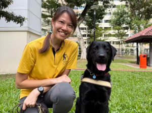 Guide dog mobility instructor Christina poses with a guide dog